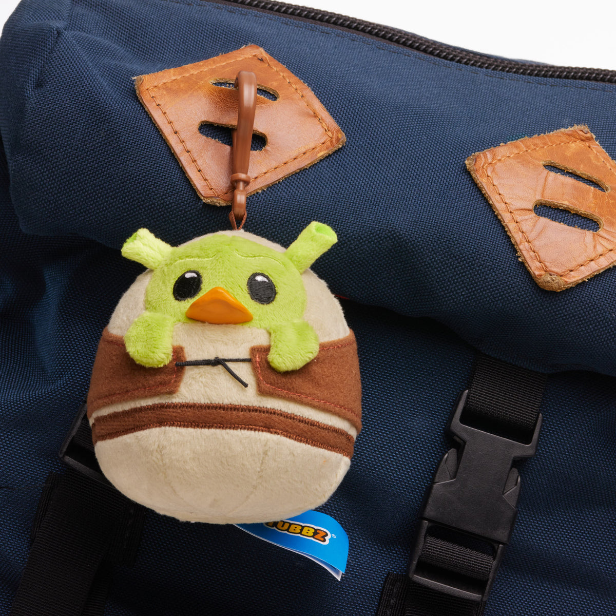 TUBBZ Shrek plush bag charm keychain shown as a bag accessory