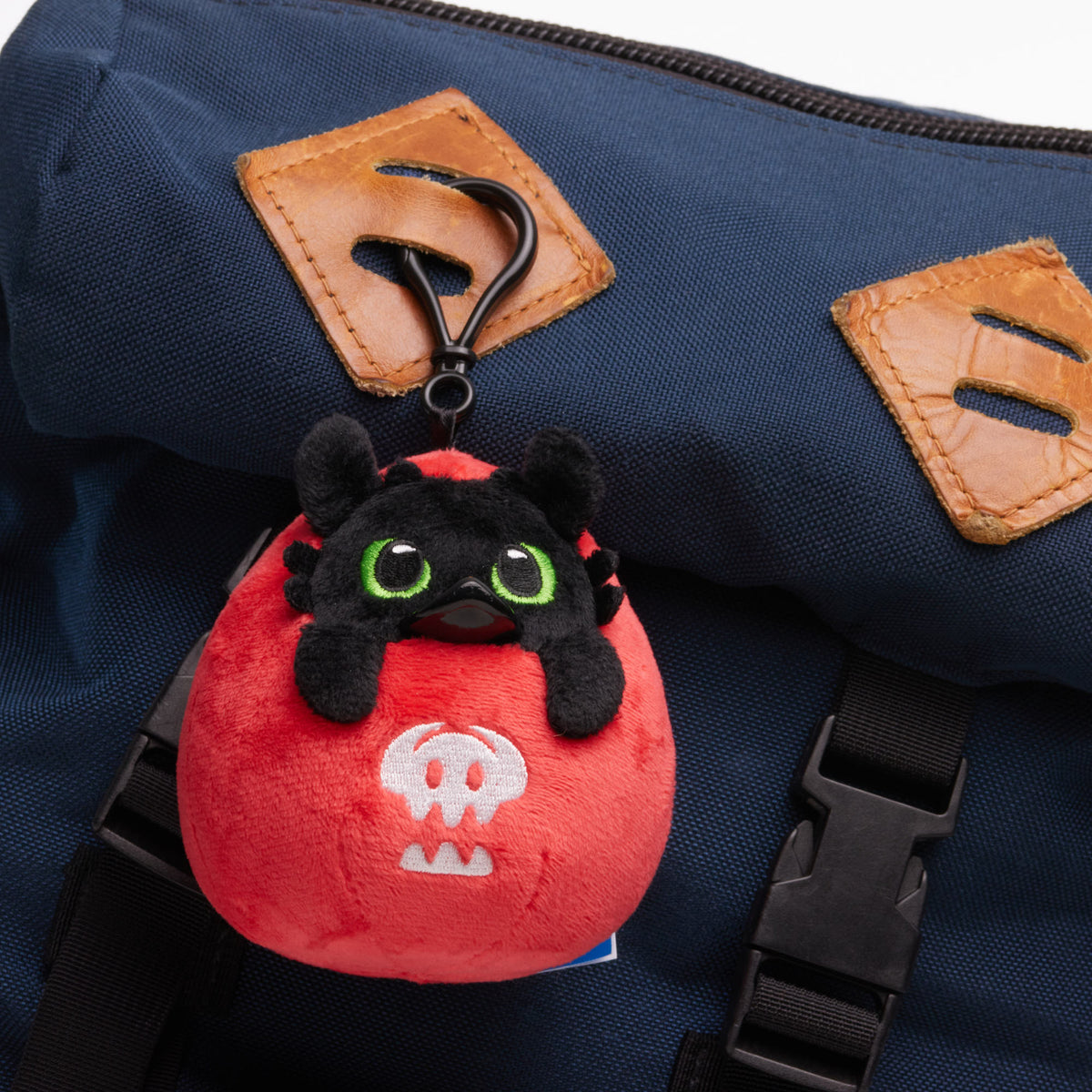 TUBBZ Toothless plush bag charm keychain shown as a bag accessory